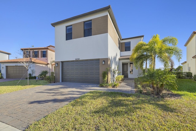 view of front of home with a front lawn and a garage