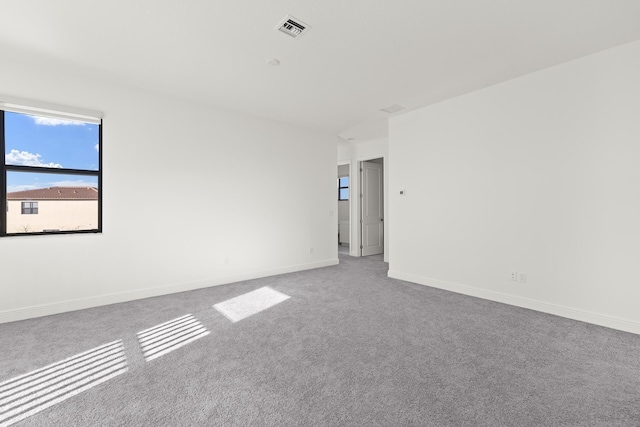 unfurnished room featuring light colored carpet