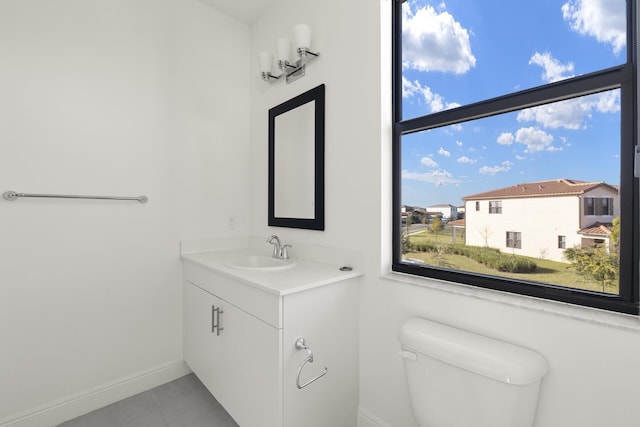 bathroom with tile patterned floors, vanity, and toilet