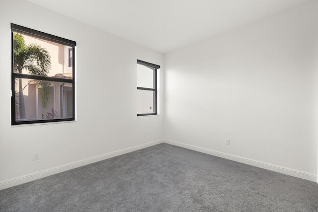 empty room with dark carpet