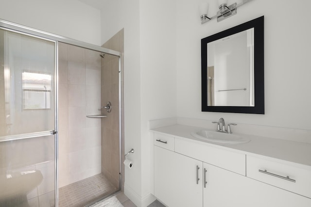 bathroom featuring vanity and an enclosed shower