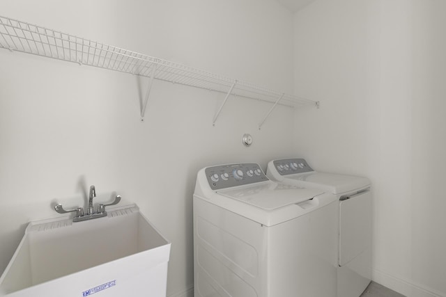 laundry room featuring washing machine and dryer and sink