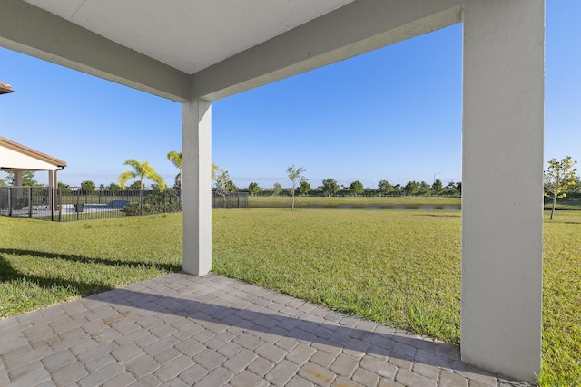 view of yard with a patio and a water view