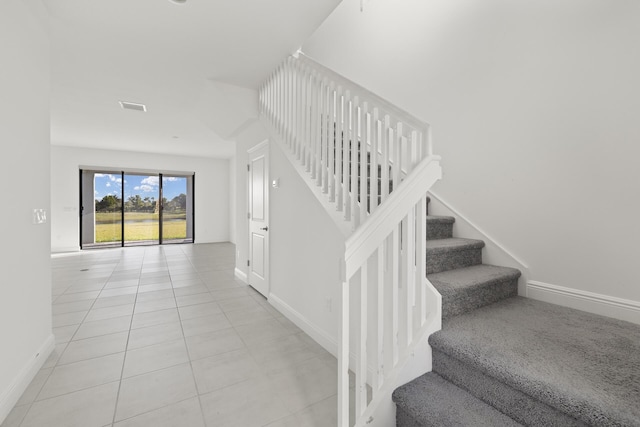 staircase with tile patterned floors