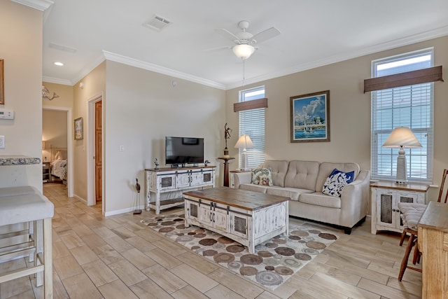 living room featuring light hardwood / wood-style floors, plenty of natural light, and crown molding