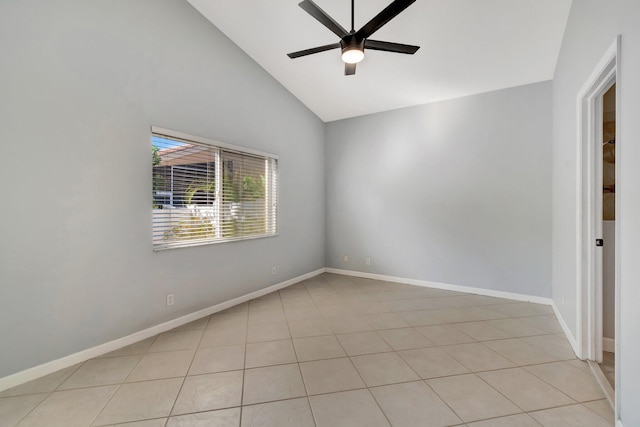 tiled empty room with ceiling fan and high vaulted ceiling