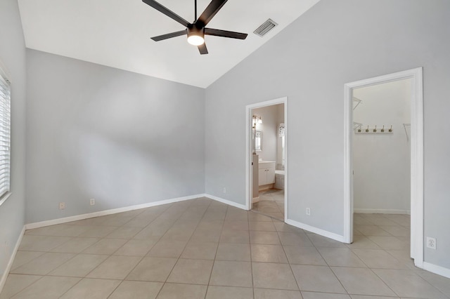 unfurnished bedroom featuring ensuite bath, a spacious closet, ceiling fan, and high vaulted ceiling