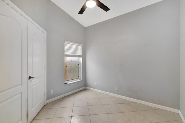 tiled spare room with ceiling fan and lofted ceiling