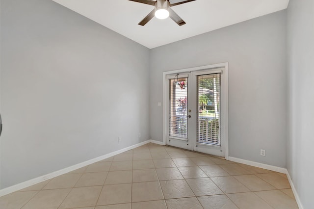 empty room featuring french doors, light tile patterned floors, ceiling fan, and lofted ceiling