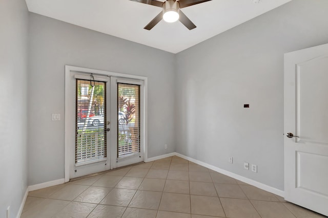 spare room featuring light tile patterned floors and ceiling fan