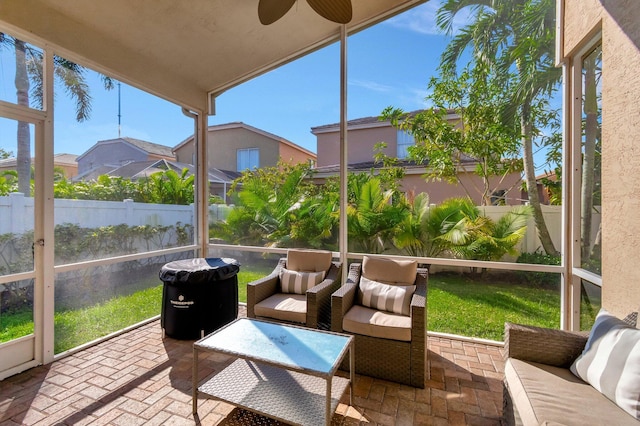 sunroom with ceiling fan