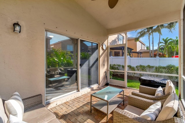 sunroom featuring ceiling fan and lofted ceiling