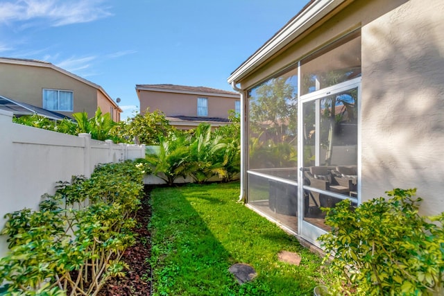 view of yard featuring a sunroom