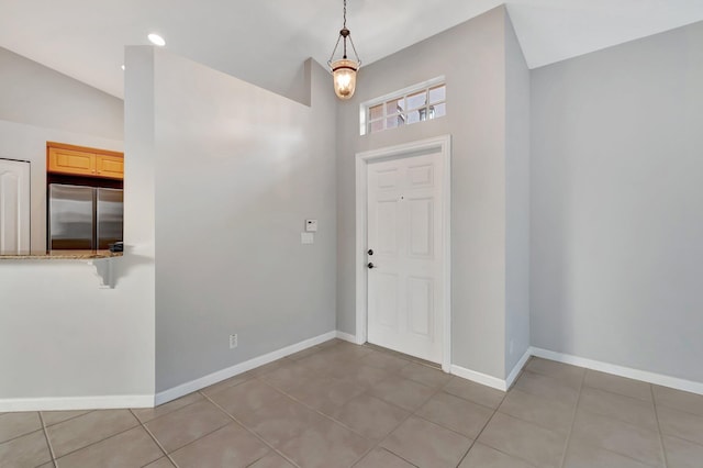 tiled foyer entrance with vaulted ceiling