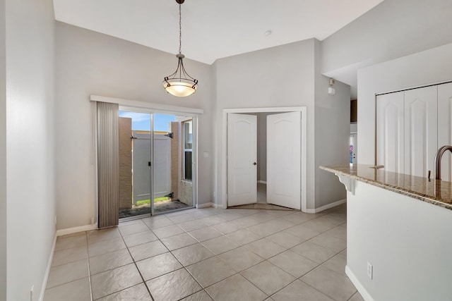 unfurnished dining area with light tile patterned floors