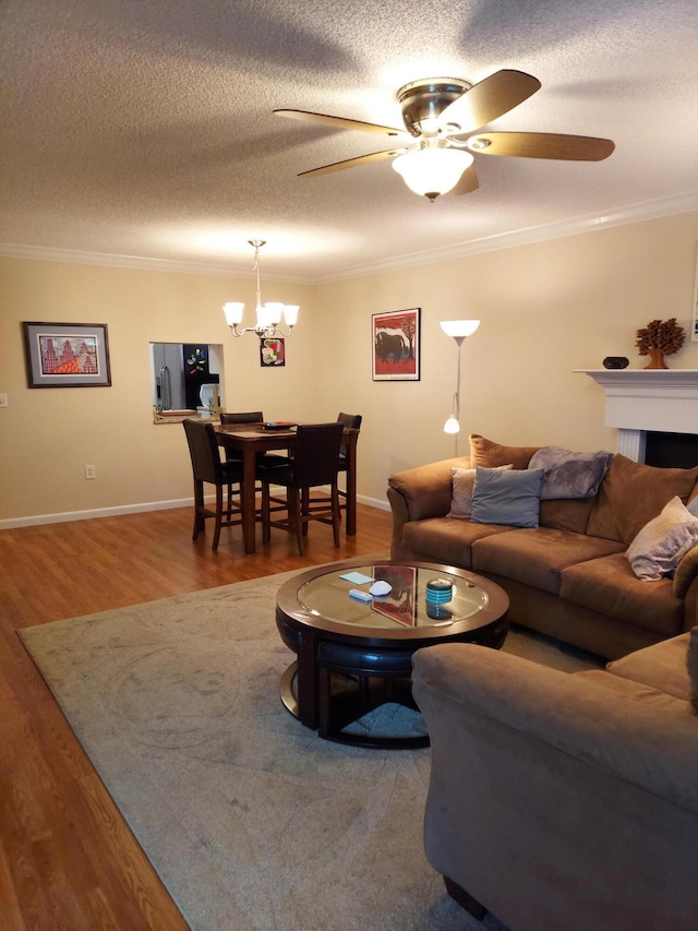 living room featuring hardwood / wood-style flooring, crown molding, and a textured ceiling