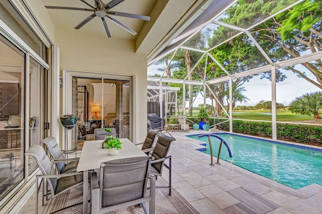 view of swimming pool featuring a lanai, a patio area, ceiling fan, and a grill