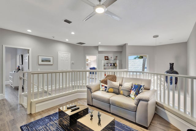 living room featuring ceiling fan and light wood-type flooring