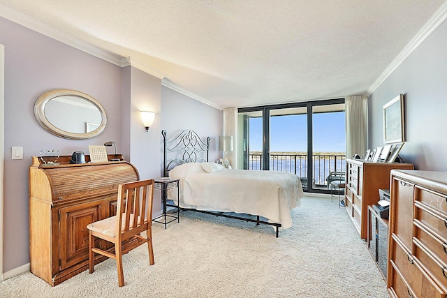 carpeted bedroom with access to exterior, floor to ceiling windows, a textured ceiling, crown molding, and a water view