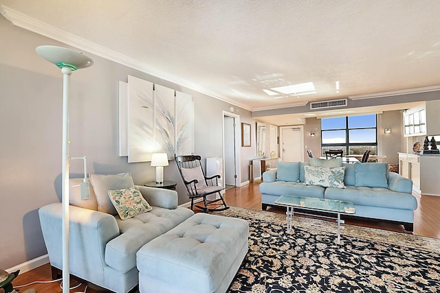 living room with a textured ceiling, hardwood / wood-style flooring, and crown molding