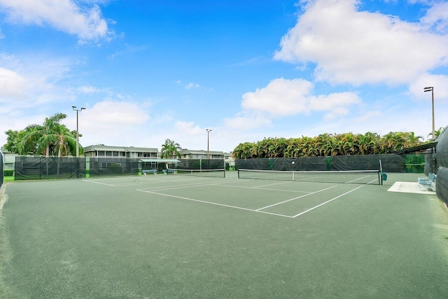 view of sport court featuring fence