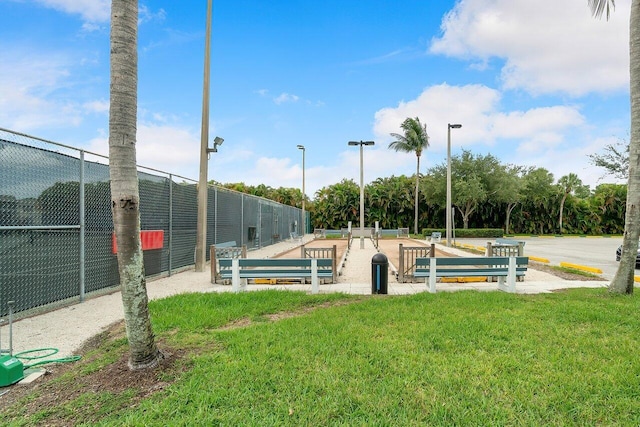 view of home's community featuring fence and a lawn