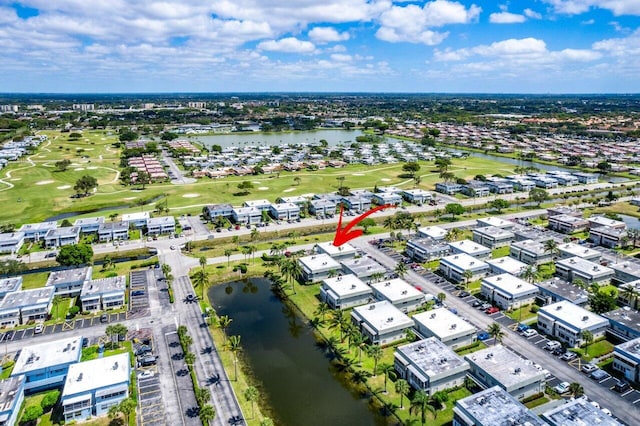 birds eye view of property featuring view of golf course and a water view