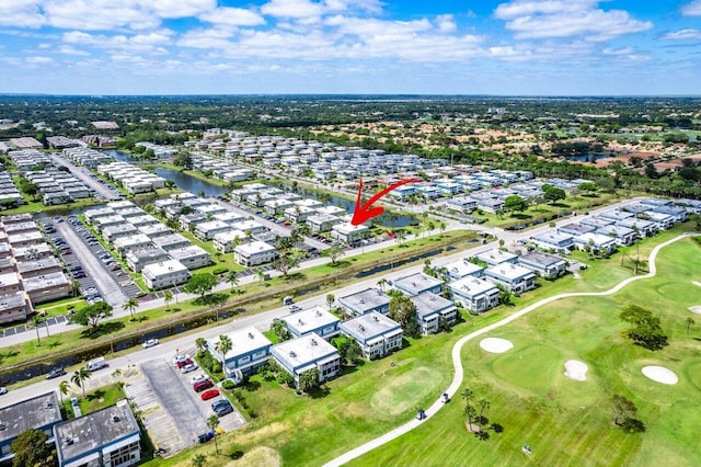 drone / aerial view featuring view of golf course and a water view