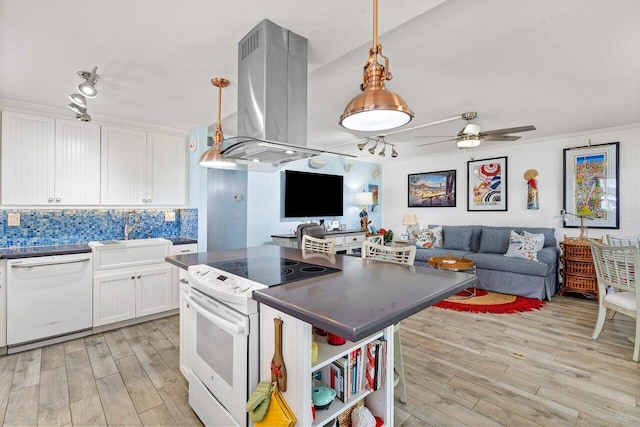 kitchen featuring white appliances, white cabinets, sink, hanging light fixtures, and island exhaust hood