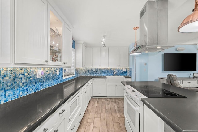 kitchen featuring dark countertops, backsplash, electric range oven, white dishwasher, and exhaust hood