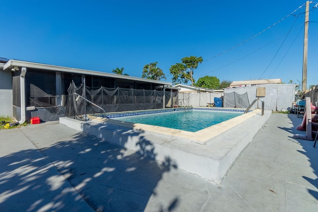 view of swimming pool with a patio area