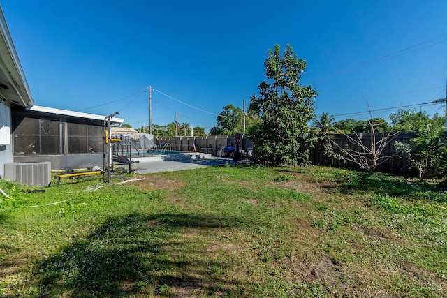 view of yard with a fenced in pool, a patio area, and cooling unit