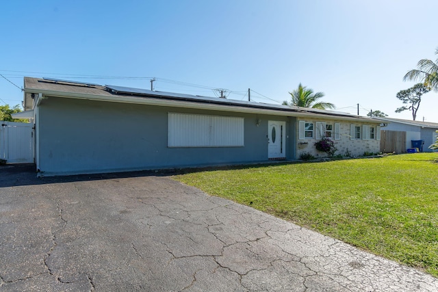 ranch-style house with a front lawn