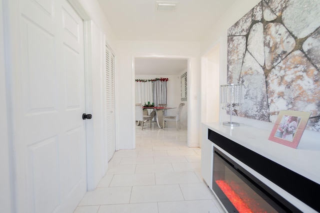 hallway featuring light tile patterned floors