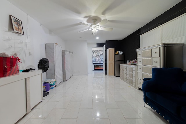 interior space featuring ceiling fan and a premium fireplace