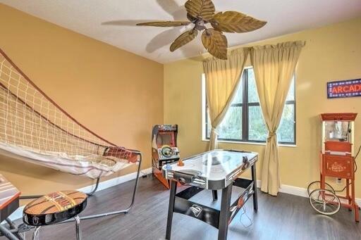 dining area with ceiling fan and dark hardwood / wood-style flooring