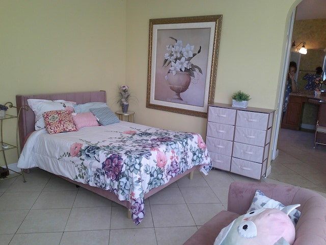 bedroom with light tile patterned floors