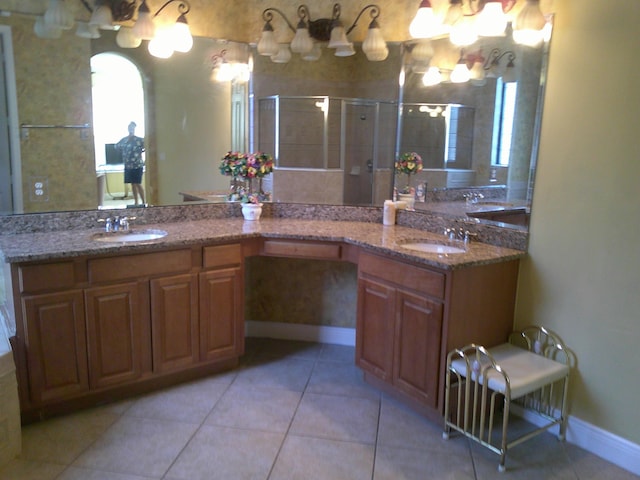 bathroom featuring tile patterned floors, vanity, and an enclosed shower