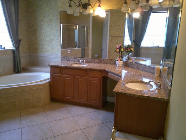 bathroom with tile patterned flooring, vanity, separate shower and tub, and a chandelier