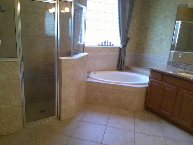 bathroom with tile patterned flooring, vanity, and shower with separate bathtub