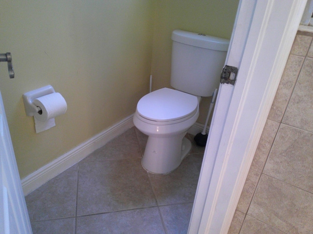 bathroom with tile patterned flooring and toilet