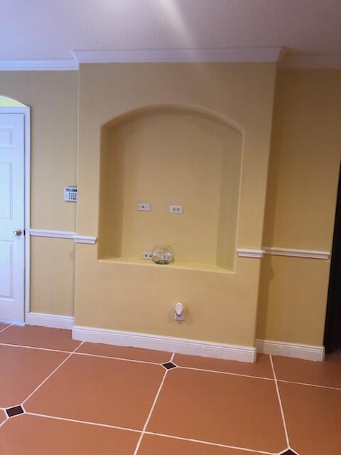 interior space featuring tile patterned flooring and crown molding