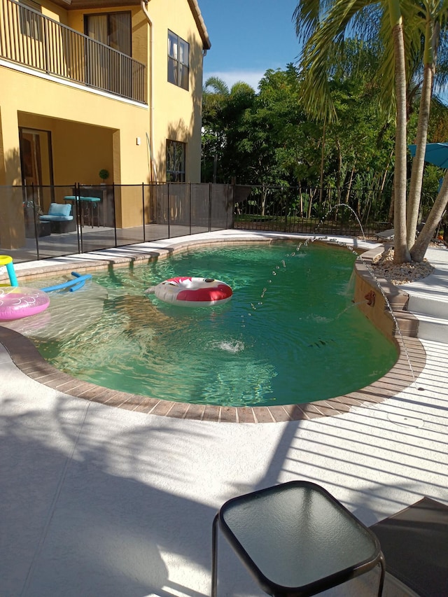 view of swimming pool featuring pool water feature