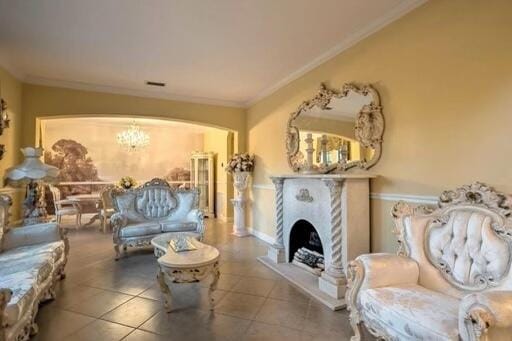 tiled living room featuring ornamental molding and a fireplace