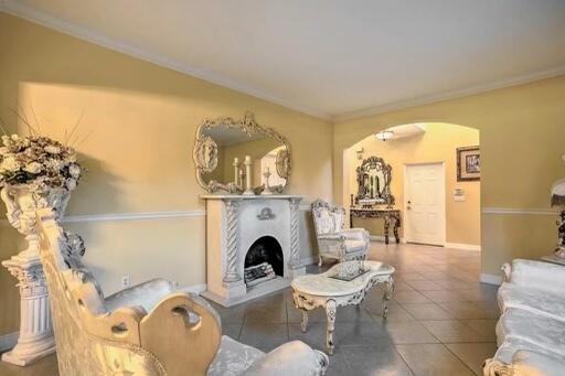 tiled living room featuring crown molding