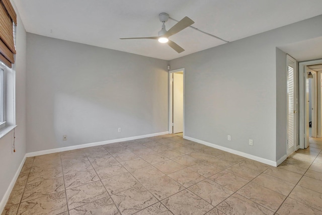 empty room featuring ceiling fan and a healthy amount of sunlight