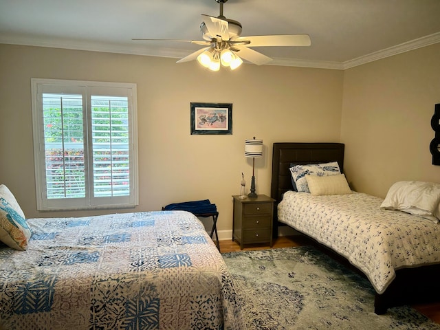 bedroom featuring ceiling fan, dark wood-type flooring, and ornamental molding