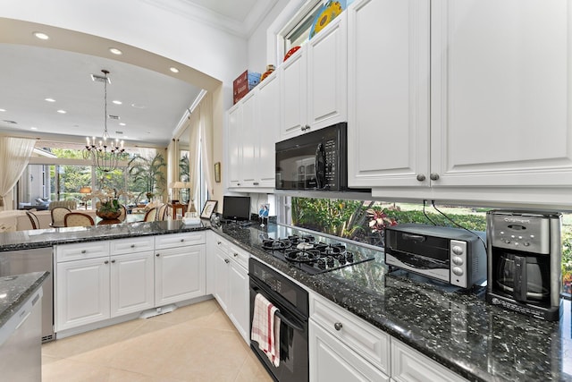 kitchen with white cabinets, an inviting chandelier, and black appliances