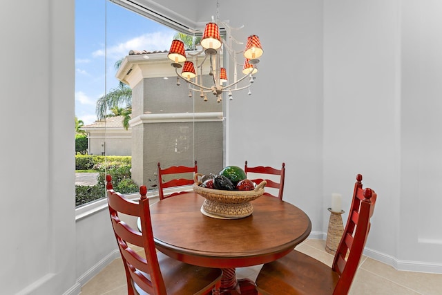 dining space with light tile patterned flooring and a chandelier