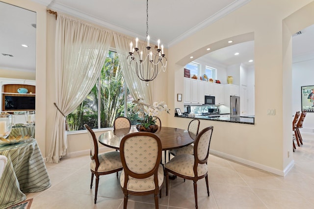 dining room featuring light tile patterned floors, a chandelier, and ornamental molding